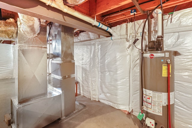 utility room featuring gas water heater and heating unit