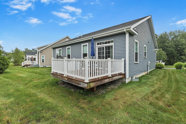 back of house with a yard and a deck