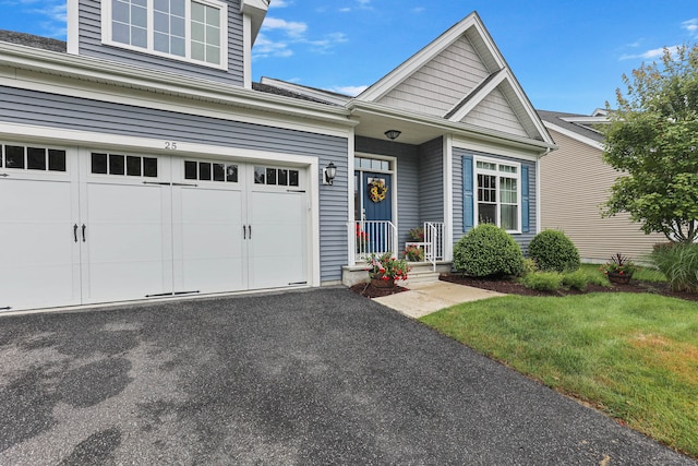 view of front of house with a garage and a front yard