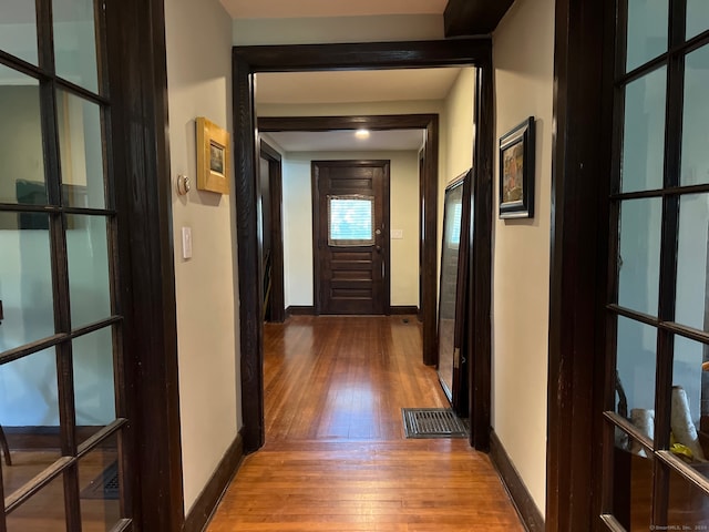 hallway with dark hardwood / wood-style floors