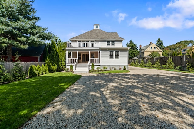 view of front of house featuring a front lawn and covered porch