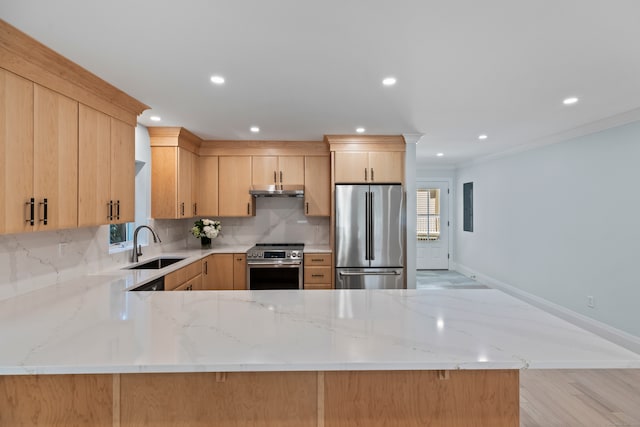 kitchen featuring light brown cabinets, sink, stainless steel appliances, and kitchen peninsula