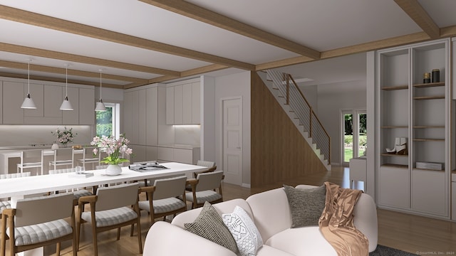 living room featuring a healthy amount of sunlight, beamed ceiling, and wood-type flooring