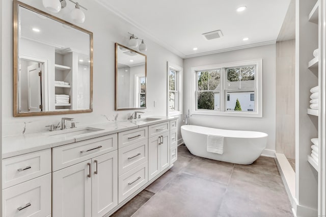 bathroom featuring crown molding, vanity, concrete floors, and a tub