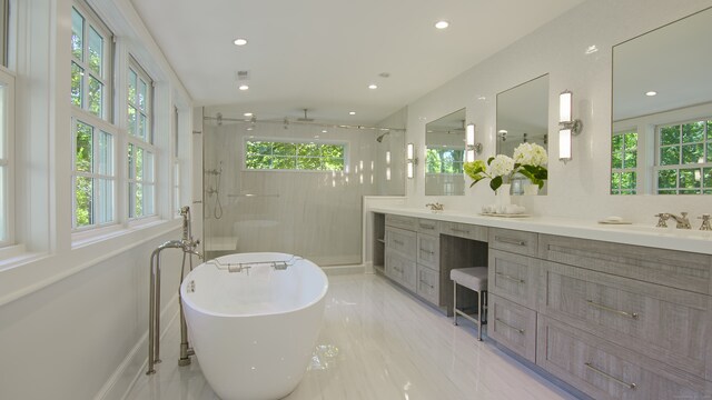 bathroom featuring vanity and plus walk in shower