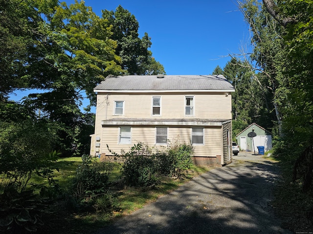 view of side of property with a storage shed