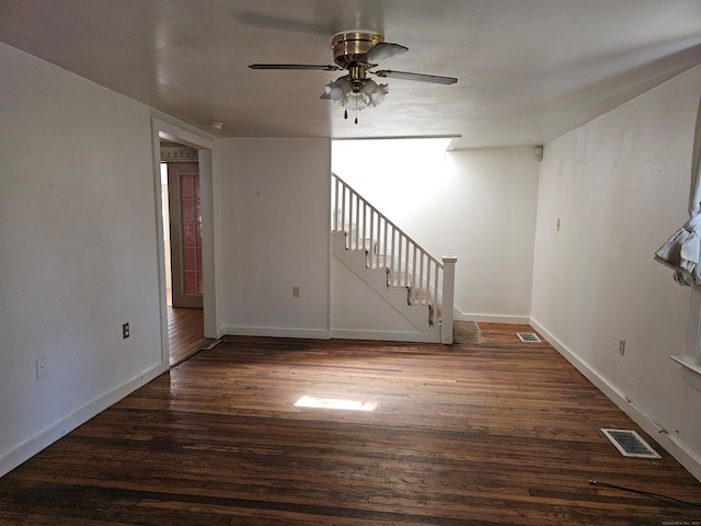 interior space featuring dark wood-type flooring and ceiling fan