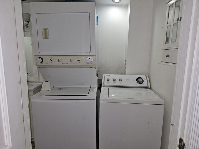 laundry room with stacked washer / dryer