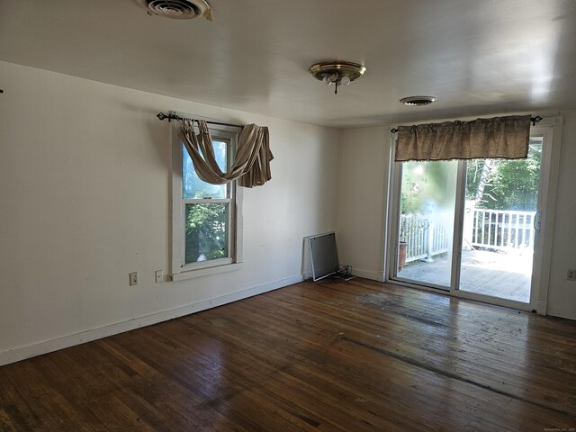 spare room featuring dark wood-type flooring