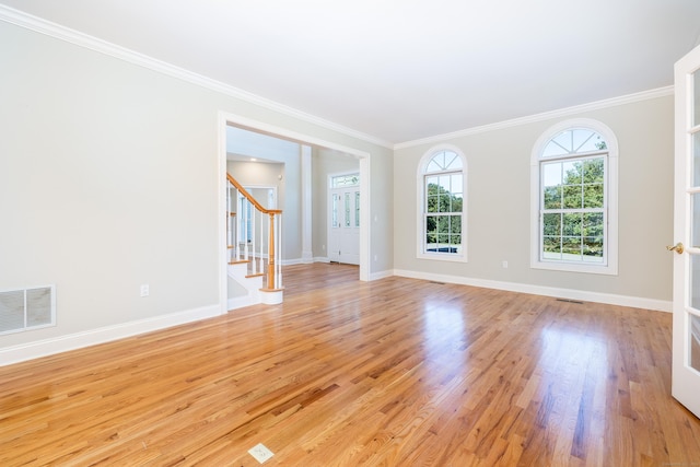 unfurnished room with light hardwood / wood-style flooring and crown molding