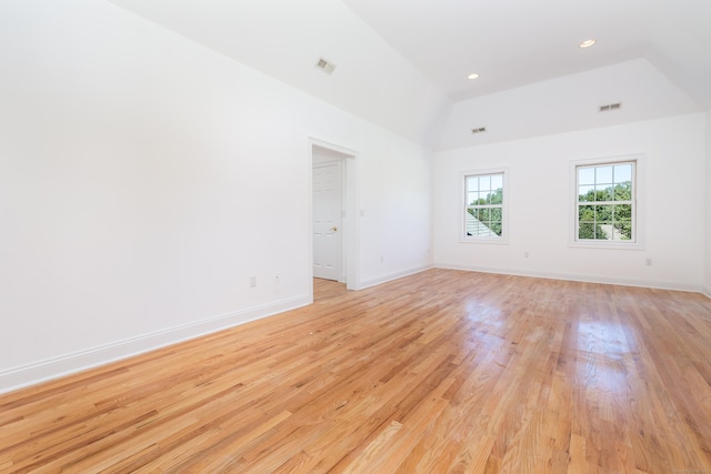 empty room featuring light hardwood / wood-style flooring and lofted ceiling