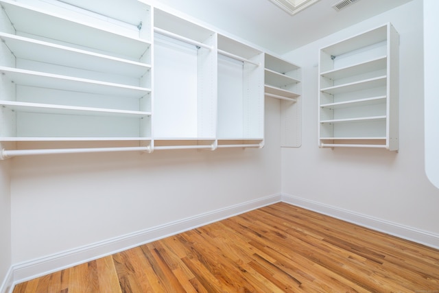 spacious closet with hardwood / wood-style flooring