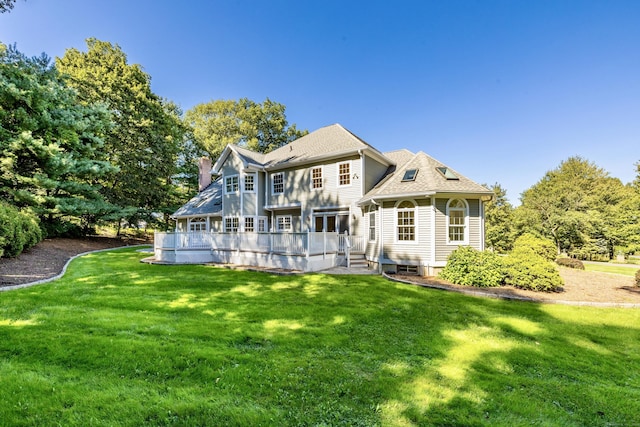 back of house featuring a yard