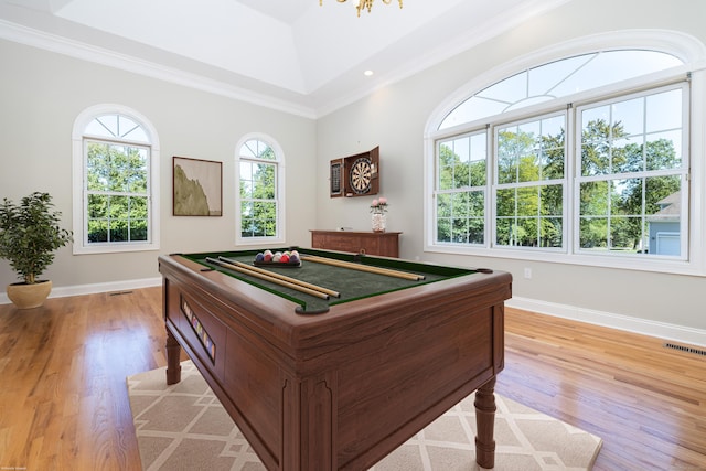 playroom with lofted ceiling, billiards, ornamental molding, light wood-type flooring, and a tray ceiling