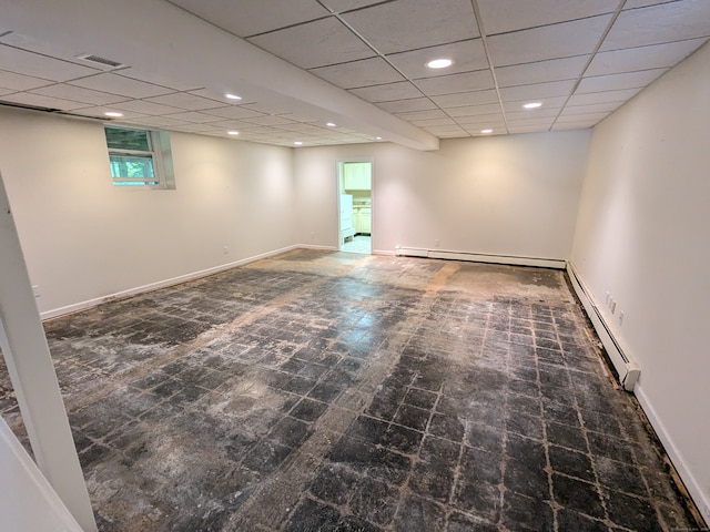 spare room with a paneled ceiling and baseboard heating