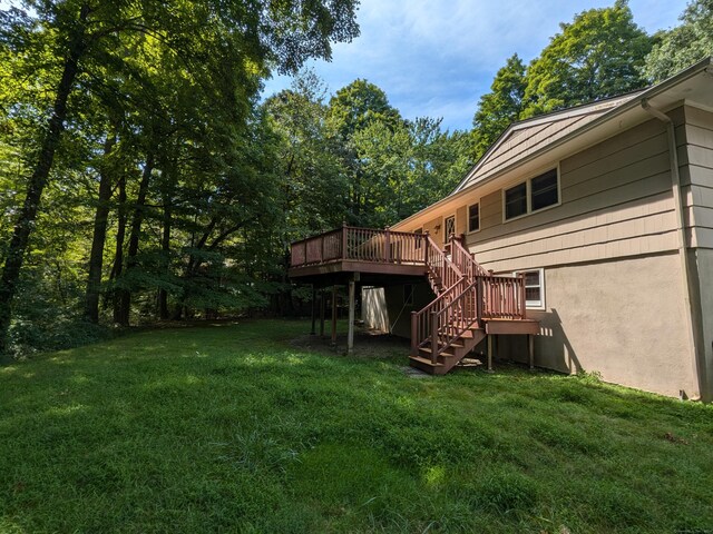 view of yard featuring stairway and a deck