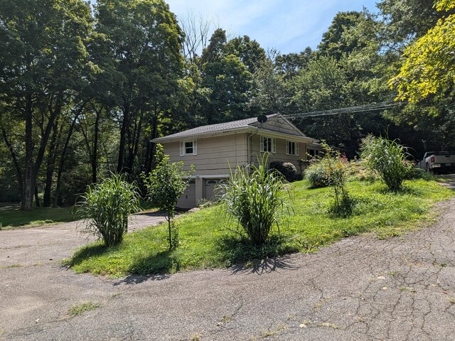 view of side of property with an attached garage and driveway