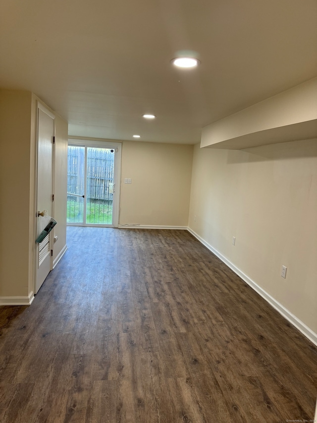 unfurnished living room with dark hardwood / wood-style flooring