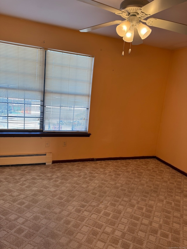 carpeted spare room featuring ceiling fan and a baseboard radiator