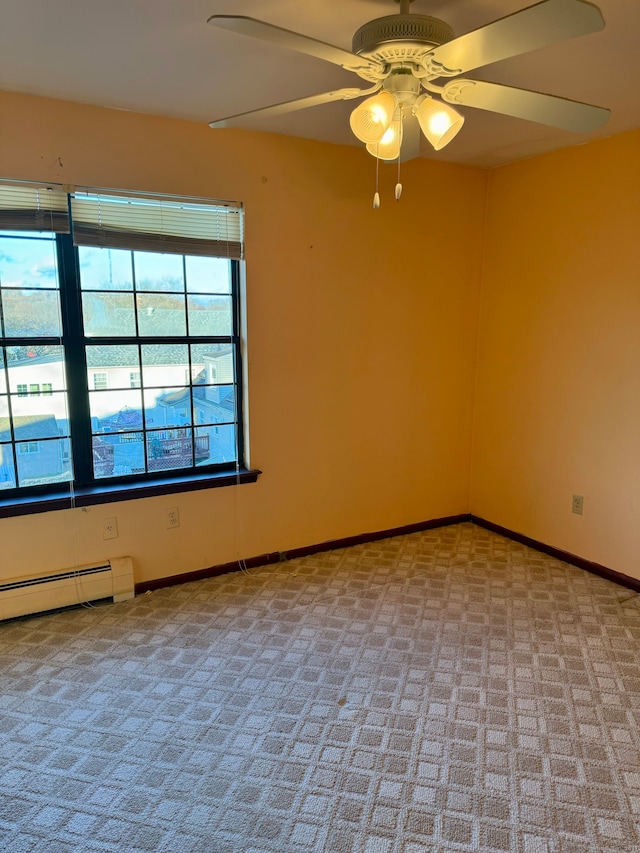 empty room with baseboard heating, light carpet, and ceiling fan