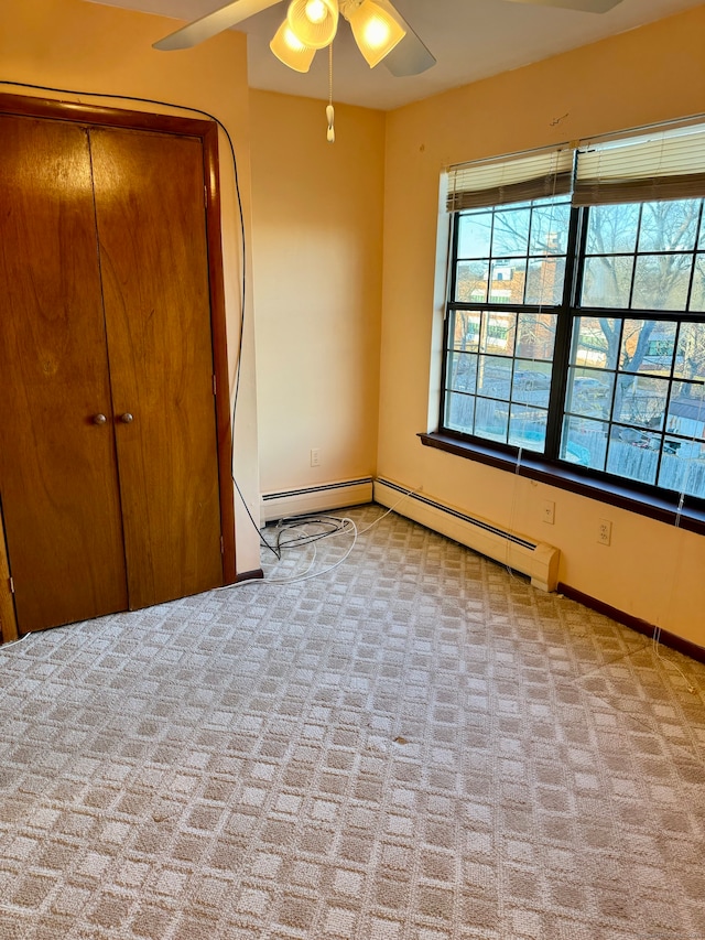 unfurnished bedroom featuring ceiling fan, a closet, and light carpet