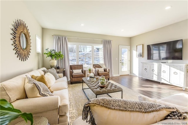 living room with recessed lighting, baseboards, and wood finished floors