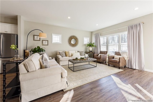 living area with recessed lighting, dark wood-style flooring, and baseboards