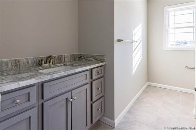 bathroom with vanity and baseboards