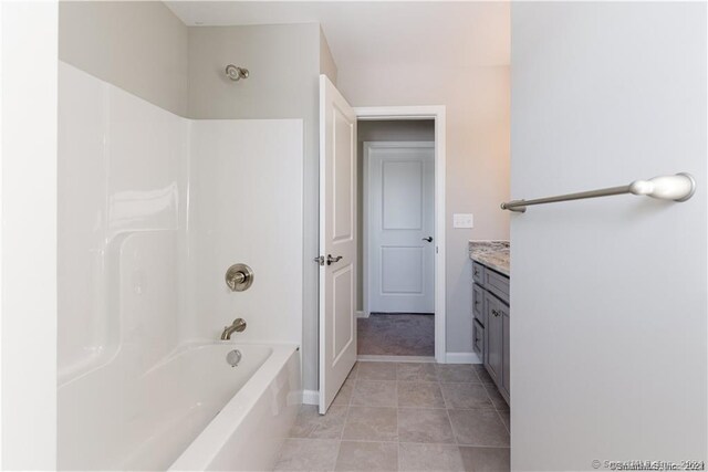 bathroom with vanity, tile patterned floors, and washtub / shower combination