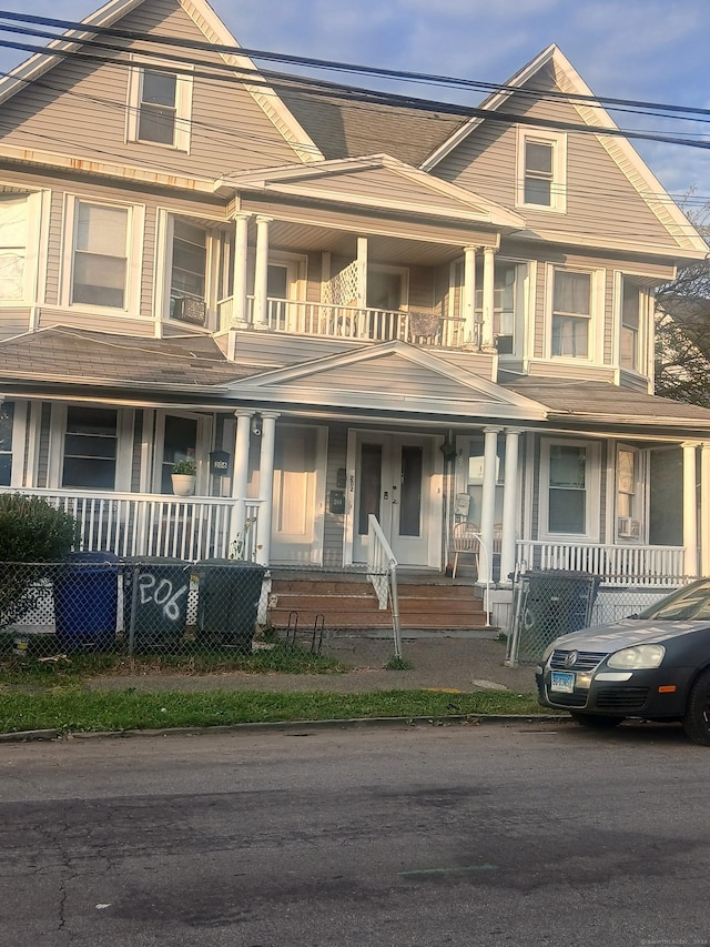 view of front of house featuring covered porch and a balcony