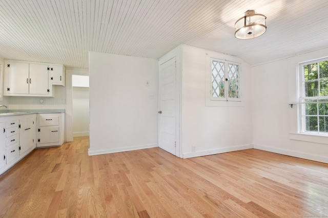 interior space with vaulted ceiling and light hardwood / wood-style floors