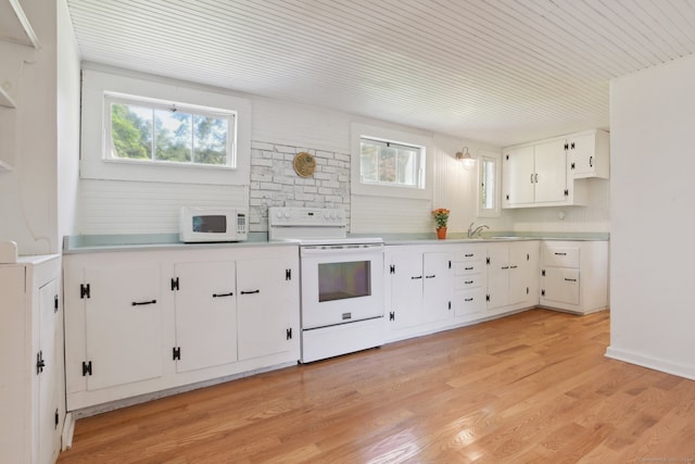 kitchen with white appliances, sink, white cabinets, and light hardwood / wood-style floors