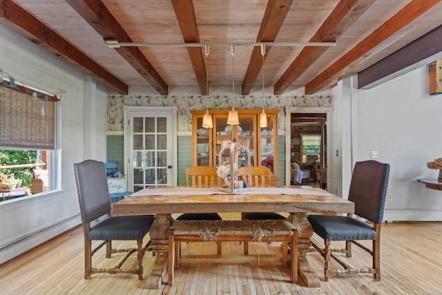 dining area with a baseboard radiator, wood ceiling, light hardwood / wood-style flooring, and beam ceiling