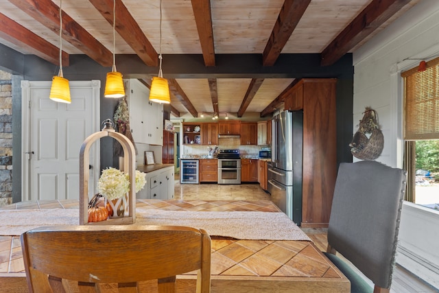 kitchen with beamed ceiling, beverage cooler, appliances with stainless steel finishes, tasteful backsplash, and kitchen peninsula