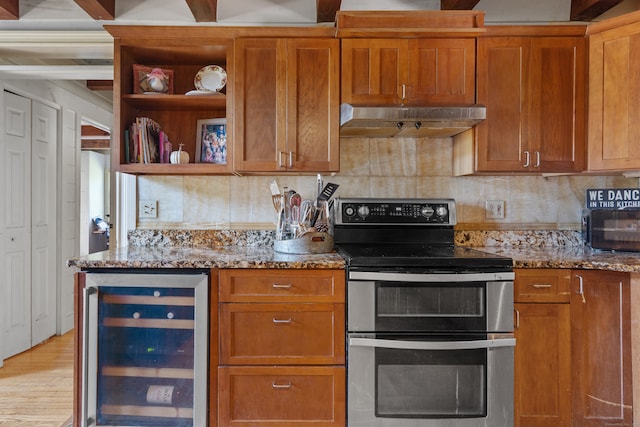 kitchen featuring backsplash, wine cooler, stainless steel electric stove, light stone counters, and light hardwood / wood-style floors