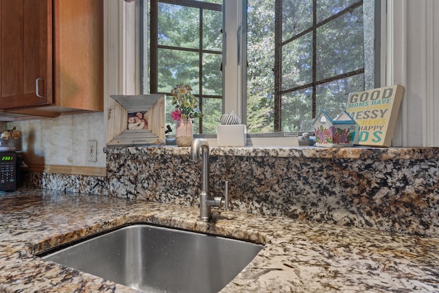 room details featuring light stone counters and sink