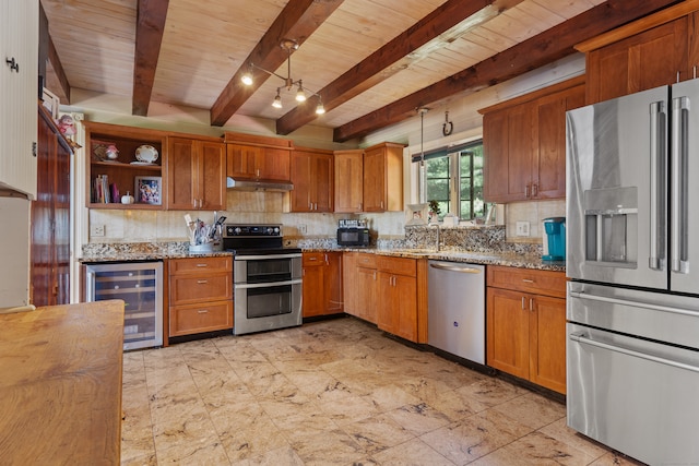 kitchen with wine cooler, beamed ceiling, light stone countertops, pendant lighting, and stainless steel appliances