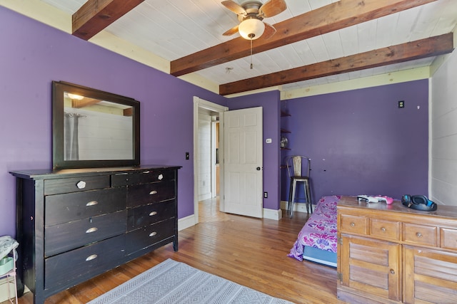 bedroom featuring hardwood / wood-style floors, ceiling fan, and beamed ceiling