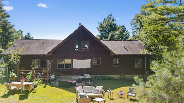 back of house featuring a yard and outdoor lounge area