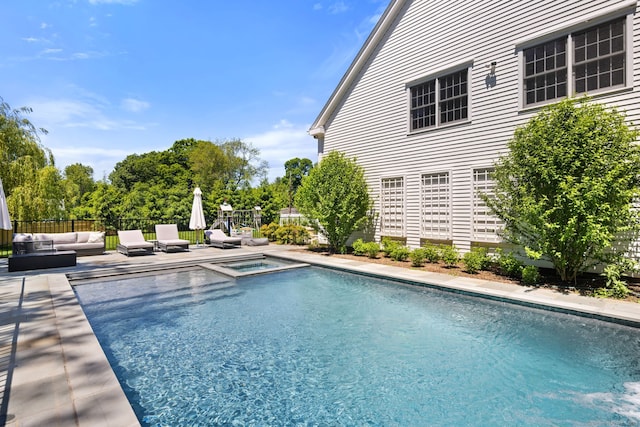 view of pool featuring a patio area, an in ground hot tub, and an outdoor living space