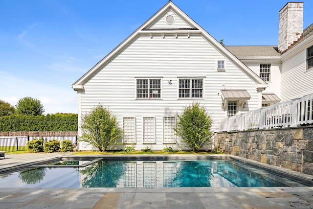 view of swimming pool with an in ground hot tub