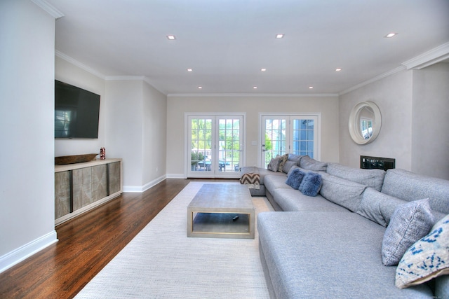 living room with dark hardwood / wood-style flooring, ornamental molding, and french doors