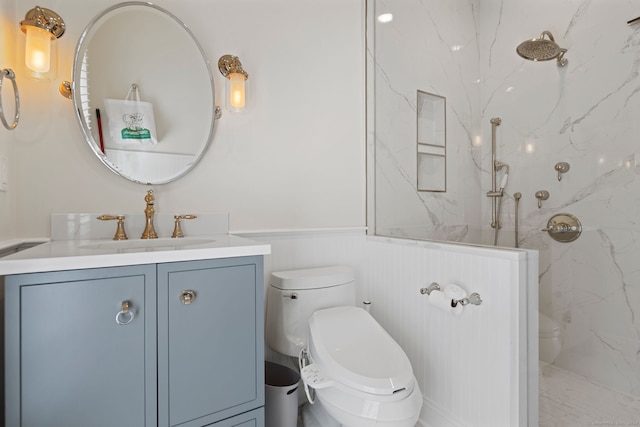 bathroom with vanity, toilet, and a tile shower