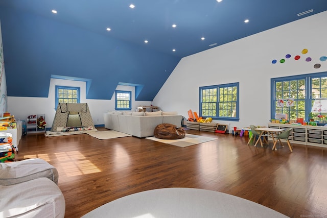 game room with high vaulted ceiling and wood-type flooring