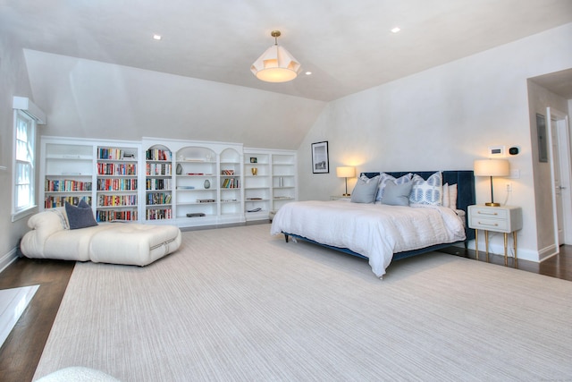 bedroom featuring dark wood-type flooring and vaulted ceiling