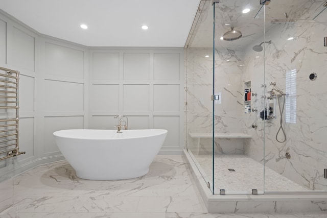 bathroom featuring separate shower and tub