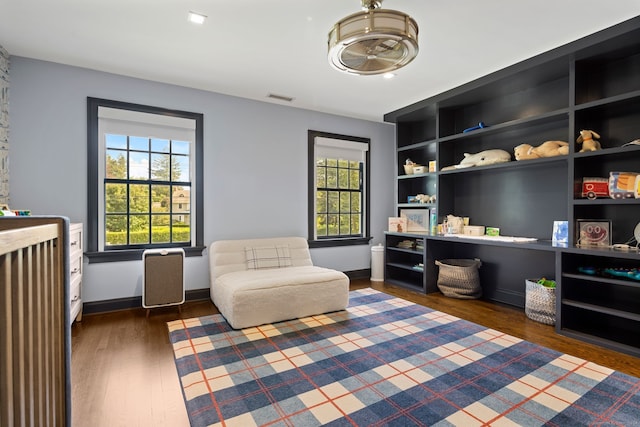 sitting room with dark hardwood / wood-style flooring and a healthy amount of sunlight