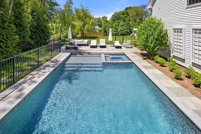 view of pool featuring a patio area, an in ground hot tub, and an outdoor living space