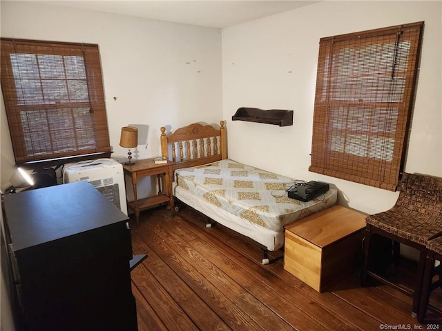 bedroom with dark hardwood / wood-style floors