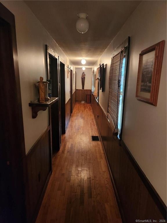 corridor with hardwood / wood-style floors